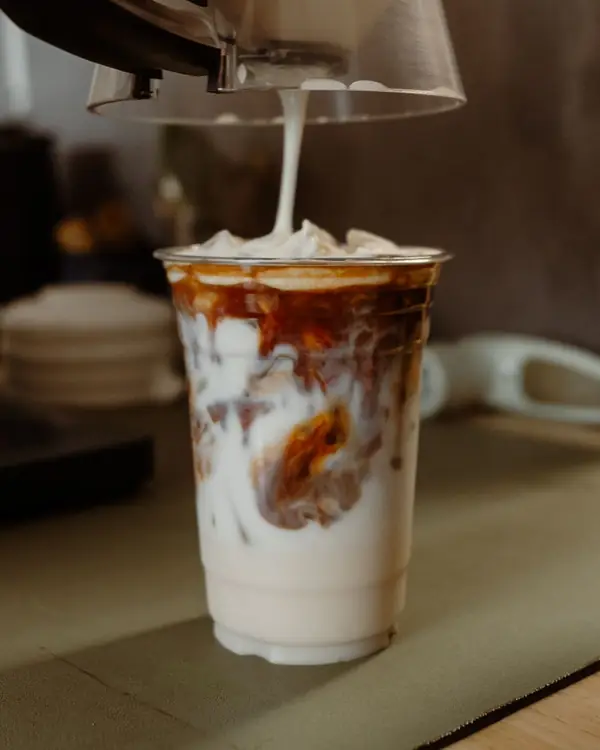 A latte being poured at Latte Haus